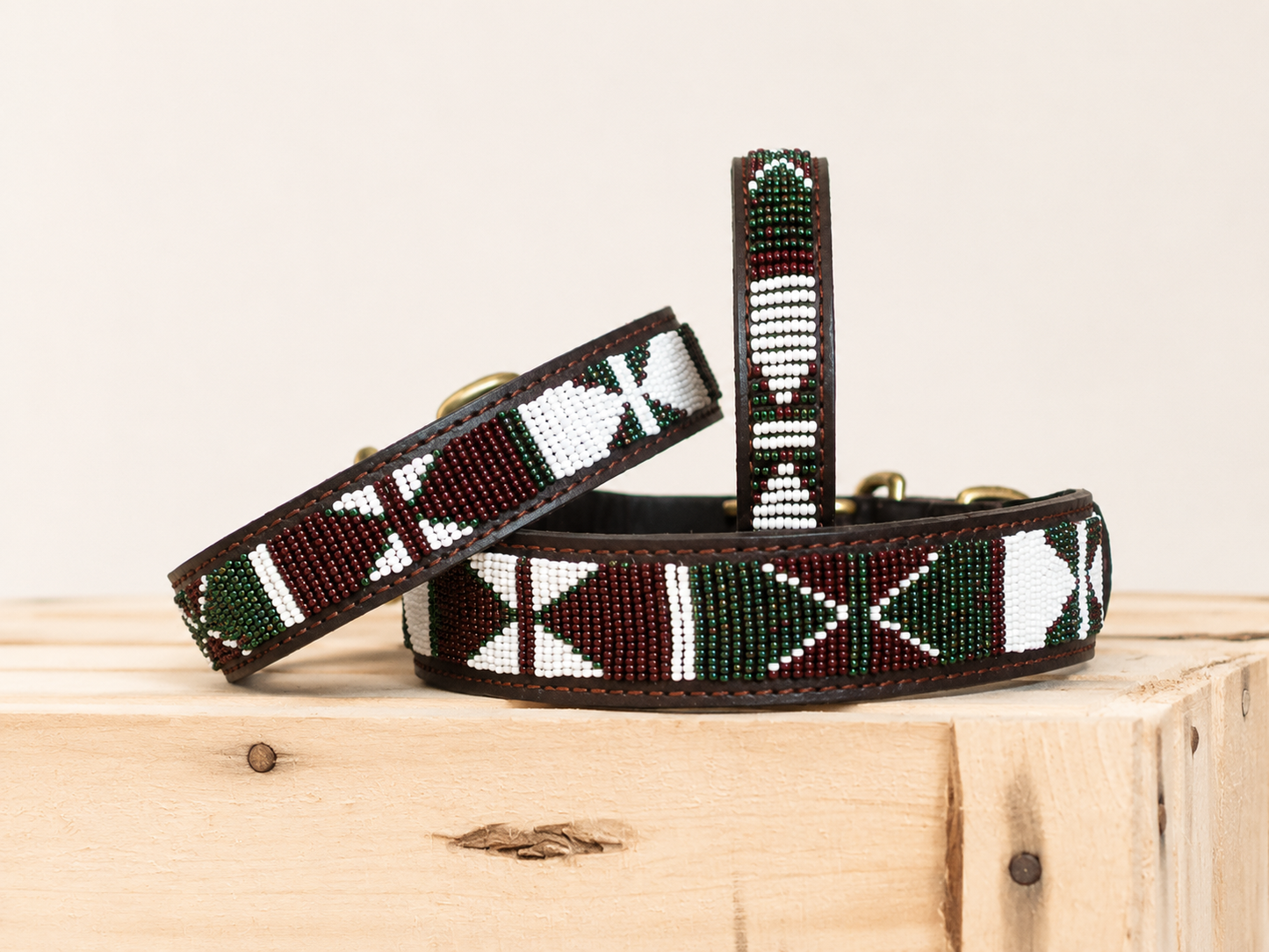 AMAZON beaded dog collars in red, white and green on a light wooden crate