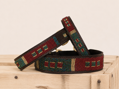 SEDONA beaded leather dog collar in burgundy, teal and gold Maasai design on wooden crate