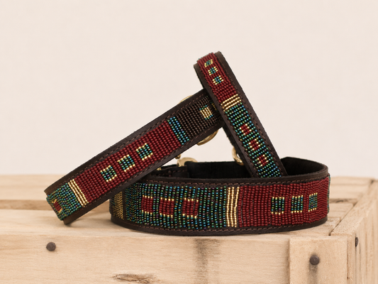SEDONA beaded leather dog collar in burgundy, teal and gold Maasai design on wooden crate